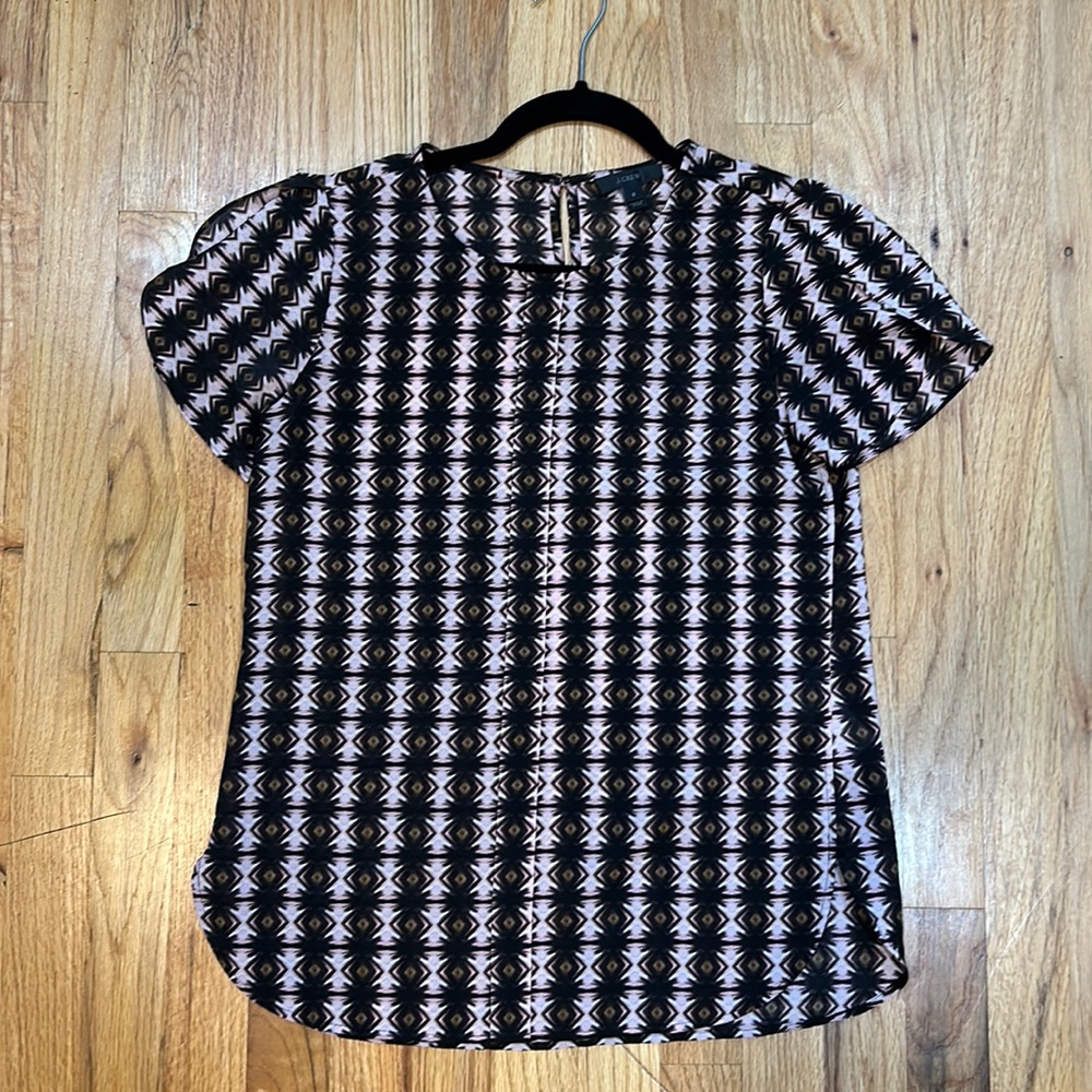 Ikat patterned work top. Print placket detail down front. Flattering rou…